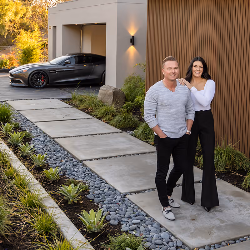 Anton Danilovich and interoeastbay Coyle in front of a modern Bay Area home